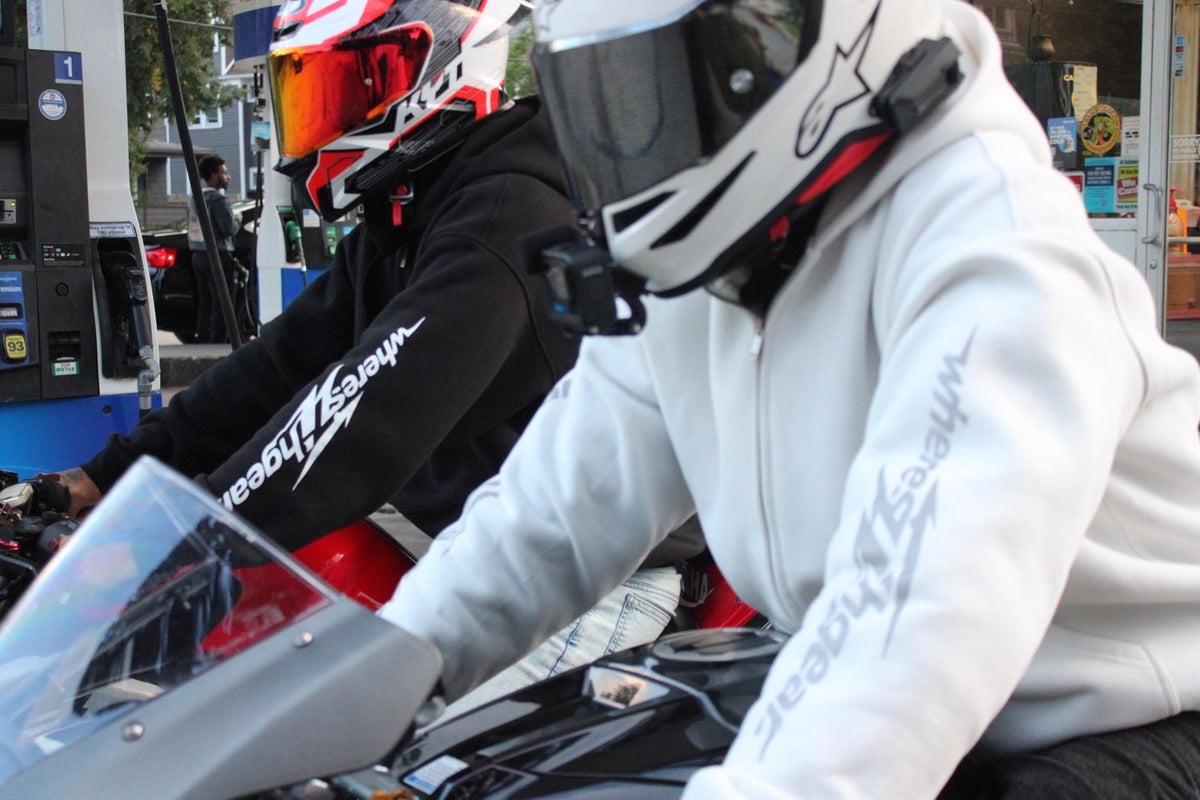 Two riders at a gas station